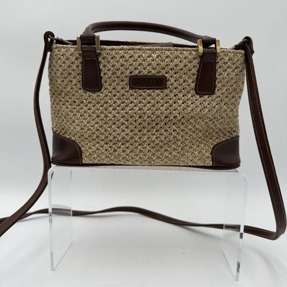 Rosetti straw tote handbag with brown faux leather trim‎ and top handles.